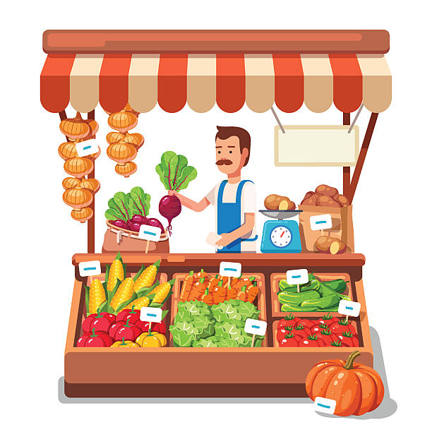 Local market farmer selling vegetables produce in his stall with awning.